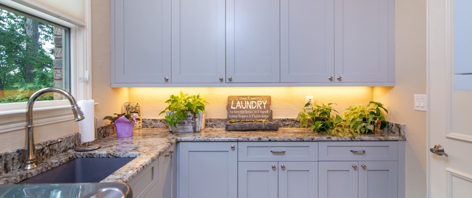 blue laundry room with a sink and a window