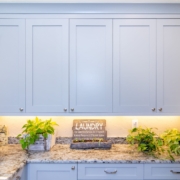 blue laundry room cabinets with lighting