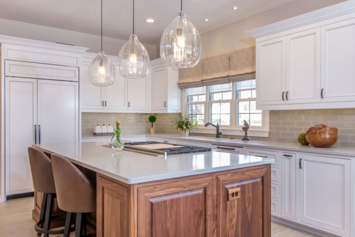 white and brown kitchen with big windows and flowers