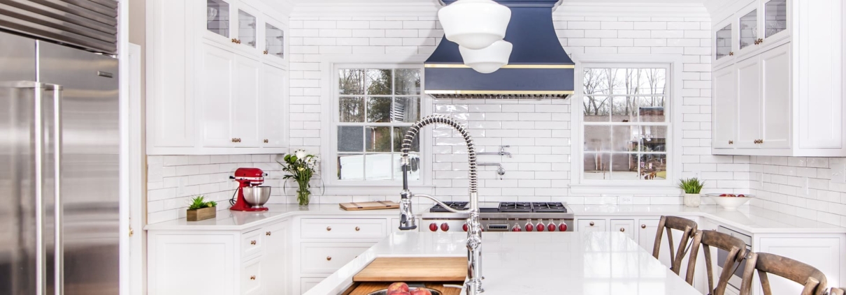 White kitchen cabinets with a island sink