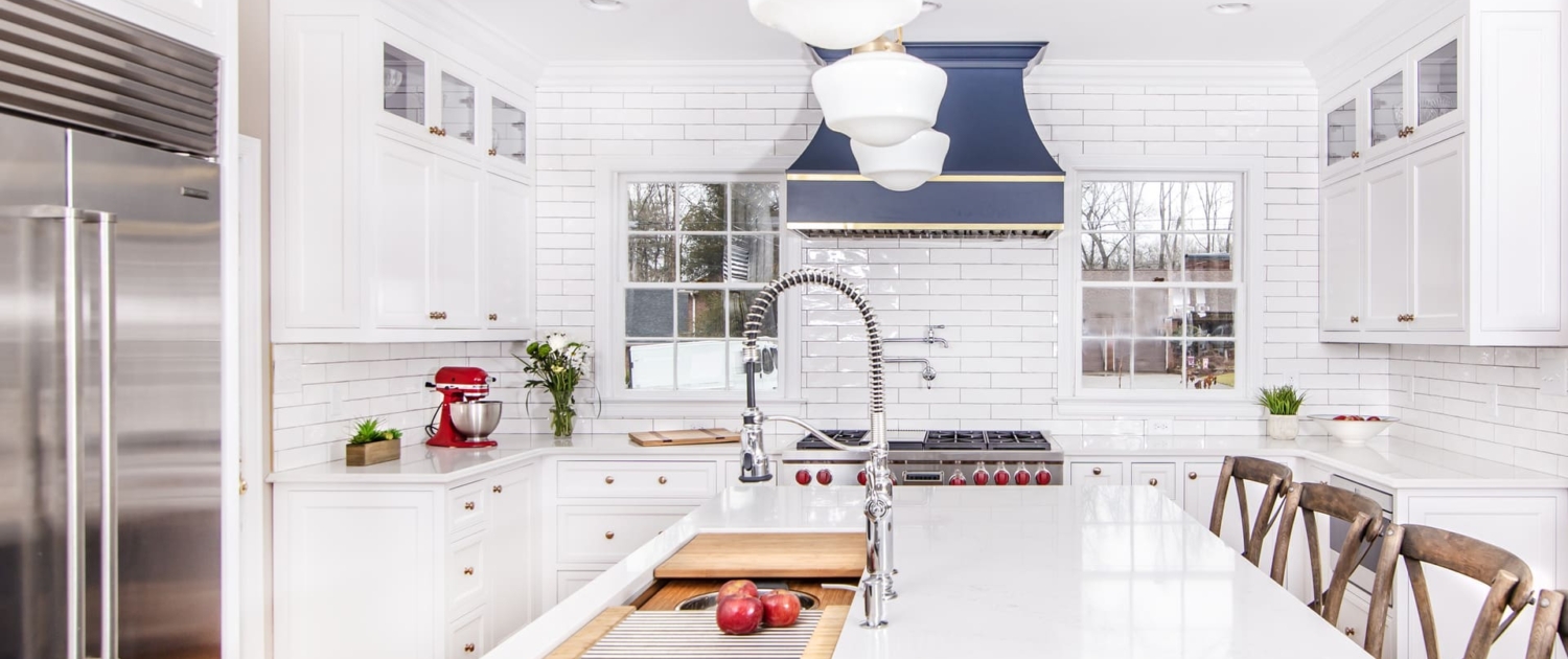 White kitchen cabinets with a island sink