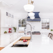 White kitchen cabinets with a island sink