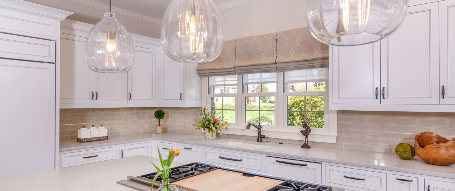white kitchen with a stove and flowers