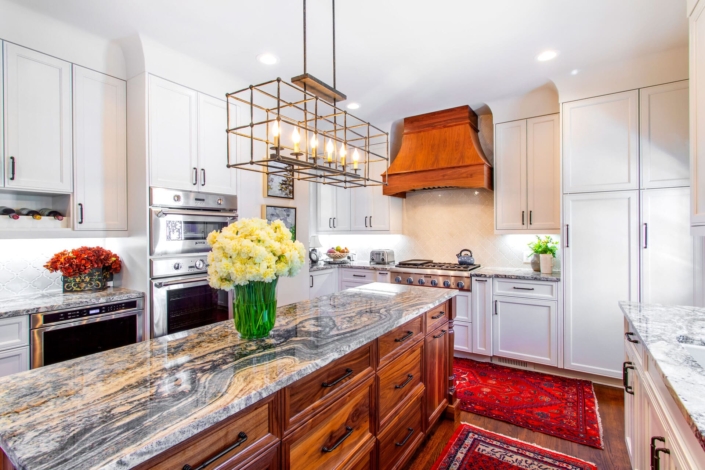 white kitchen with a walnut hood