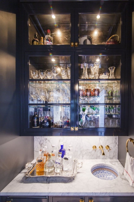 beverage center with drinks and glass cabinet doors