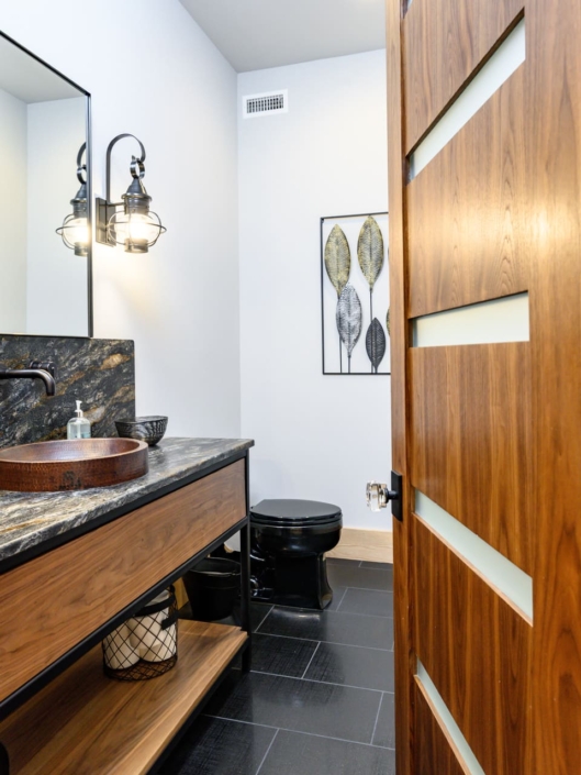 bathroom with a wooden sink and black accents