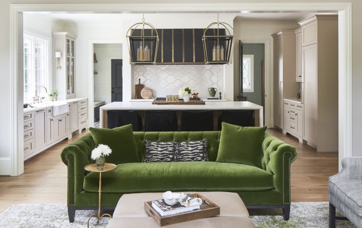 living room and a kitchen with a green couch