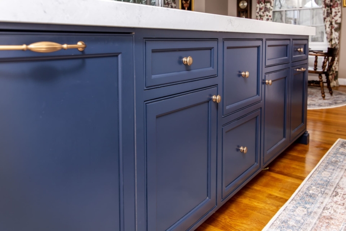 Blue kitchen island with white countertops