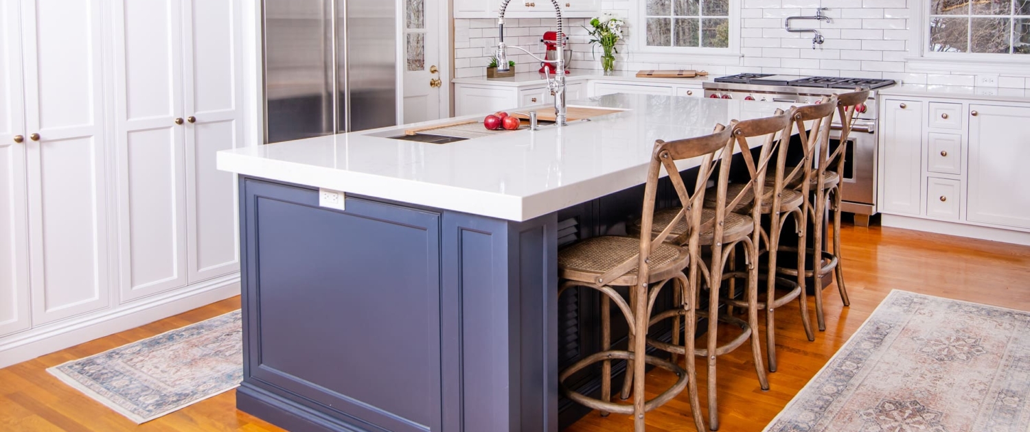 Blue kitchen island and white kitchen cabinets