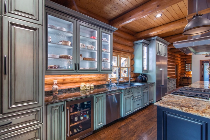 green kitchen in a log cabin