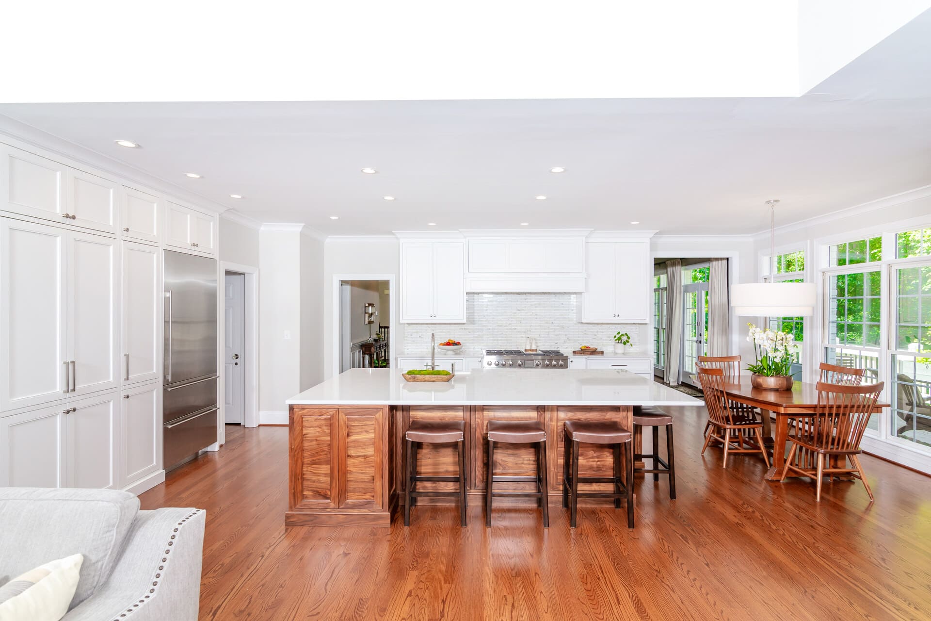 white kitchen with a brown island
