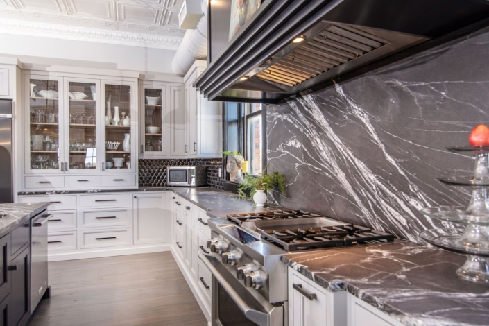 white kitchen with marble backsplash
