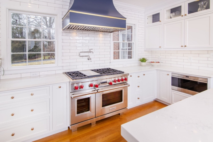 White kitchen cabinets with a blue hood