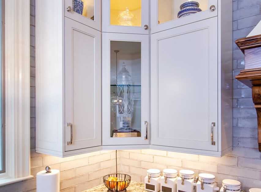 white kitchen with glass doors and lights