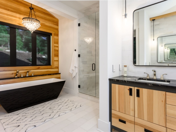 bathroom with a large tub and walk in shower