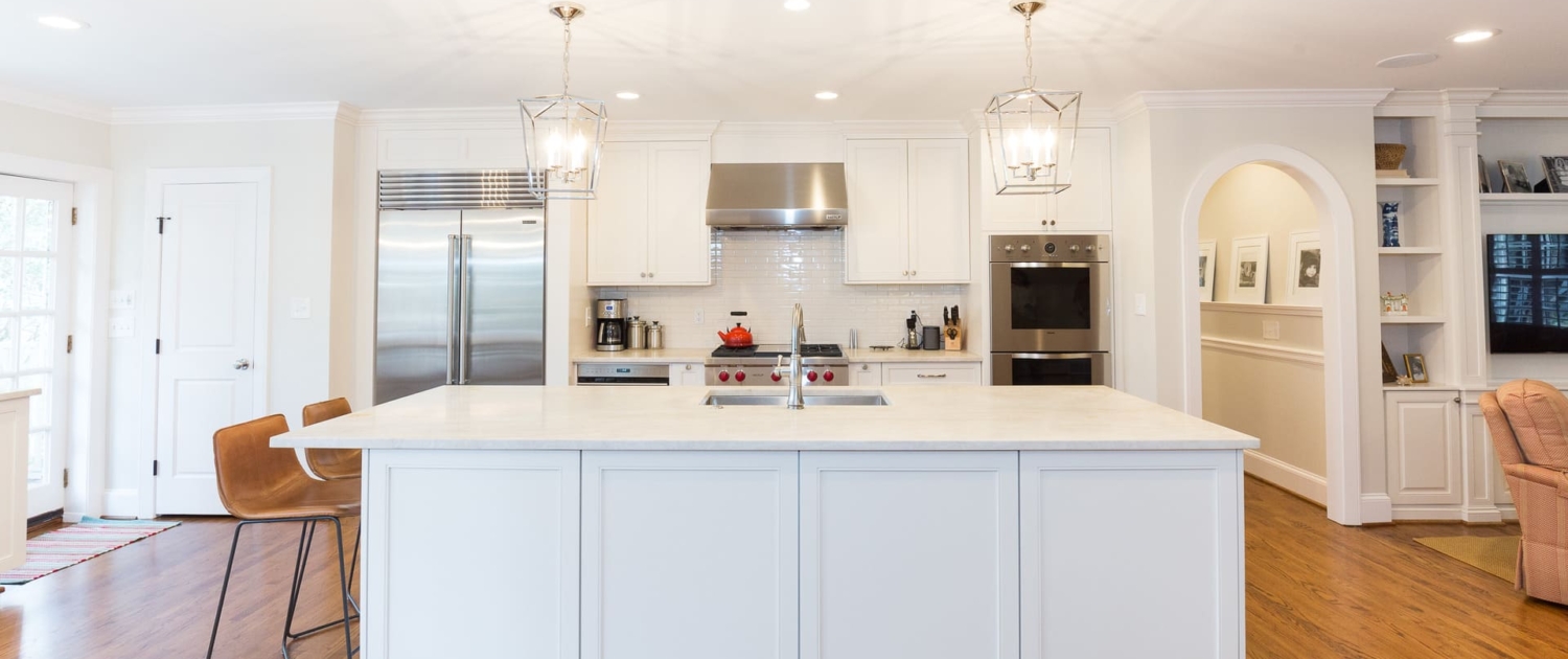 white kitchen with an island and appliances