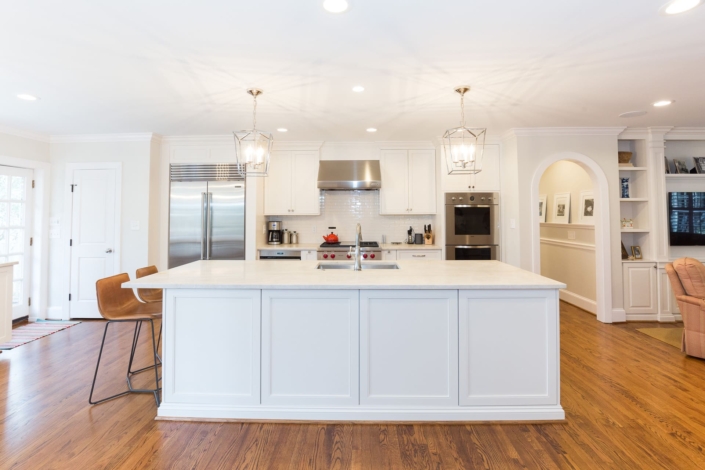 white kitchen with an island and appliances