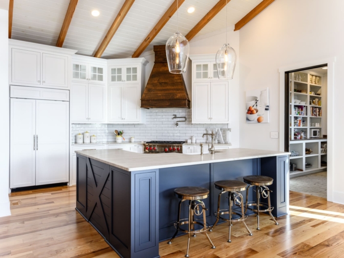 white and blue kitchen with a walk in pantry