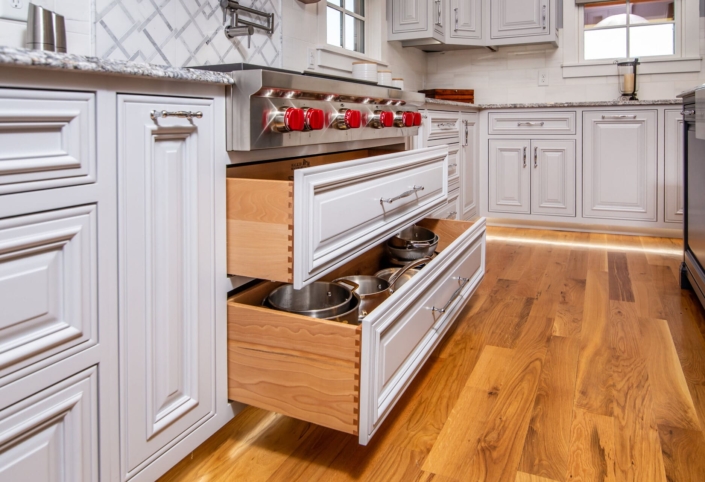 white kitchen with a drawer for pots and pans