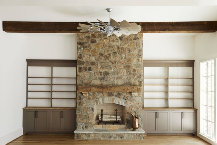 brick fireplace with a fan