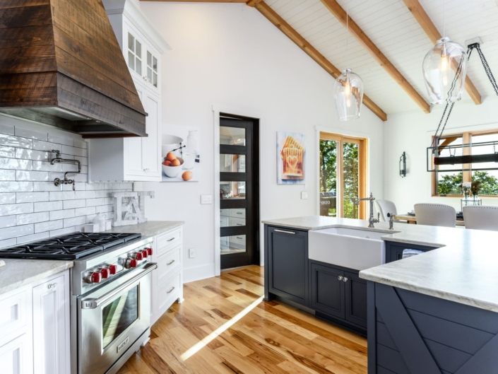 white and blue kitchen with a beautiful mountain view
