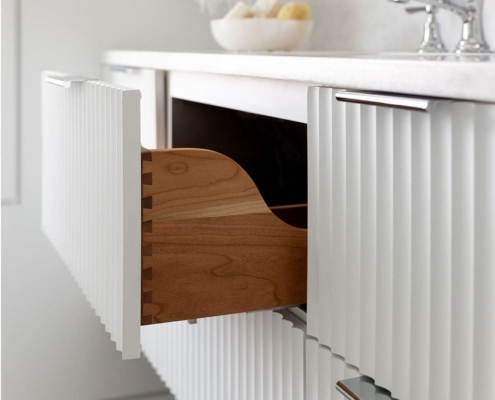 white vanity with a fluted drawer