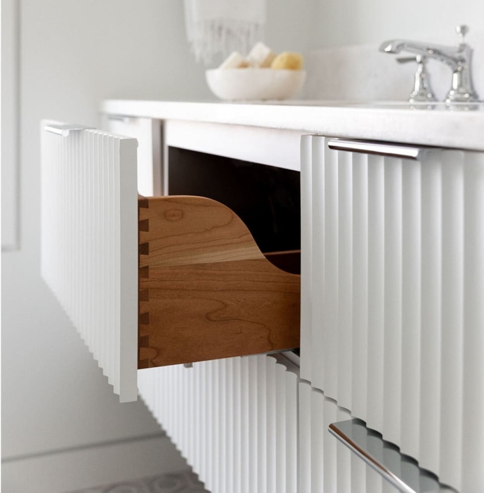 white vanity with a fluted drawer