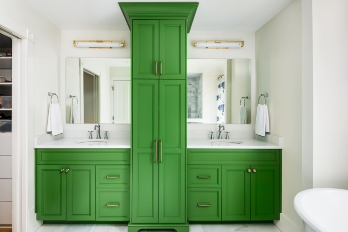 green bathroom with mirrors and lights