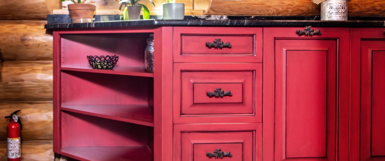 red cabinets in a log cabin