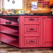red cabinets in a log cabin