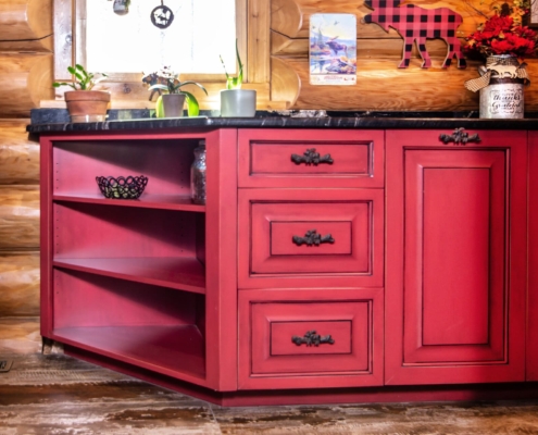 red cabinets in a log cabin