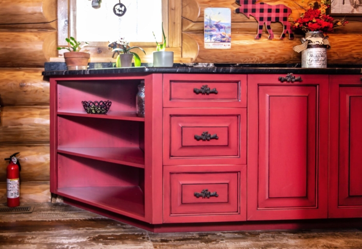 red cabinets in a log cabin