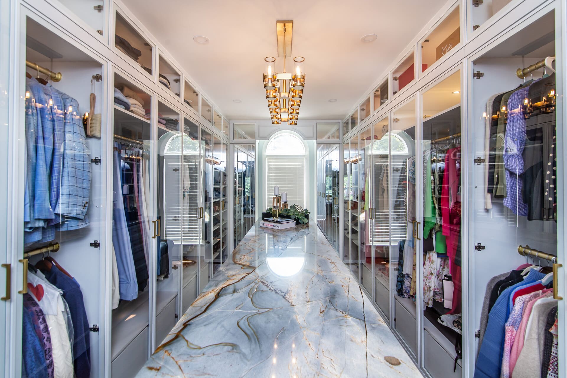 Custom closet with a large light fixture