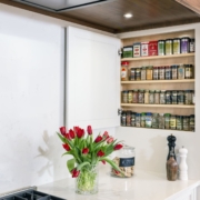 hidden spice cabinet in a white kitchen