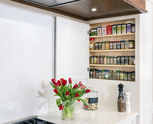 hidden spice cabinet in a white kitchen