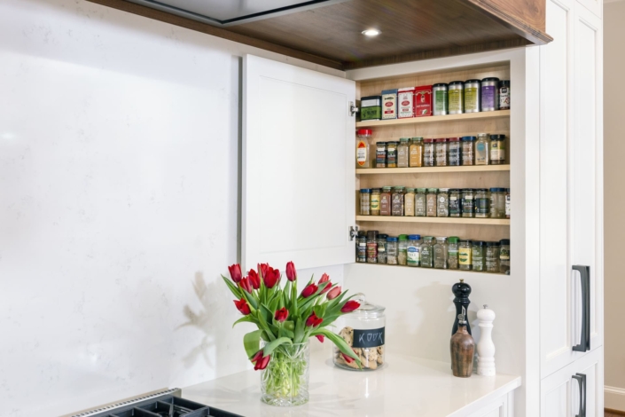 hidden spice cabinet in a white kitchen