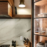 Walnut cabinets with white countertops and backsplash