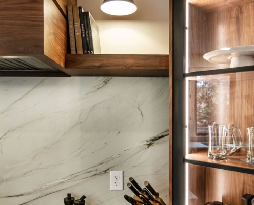 Walnut cabinets with white countertops and backsplash