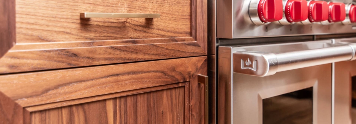 Walnut cabinets with gold hardware