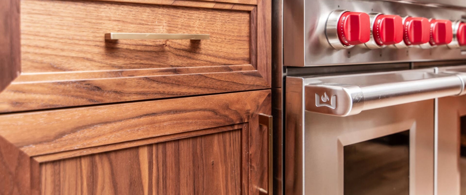 Walnut cabinets with gold hardware