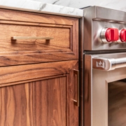 Walnut cabinets with gold hardware