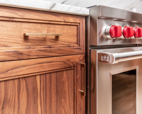 Walnut cabinets with gold hardware
