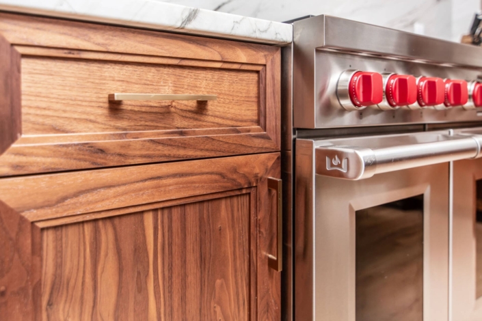 Walnut cabinets with gold hardware