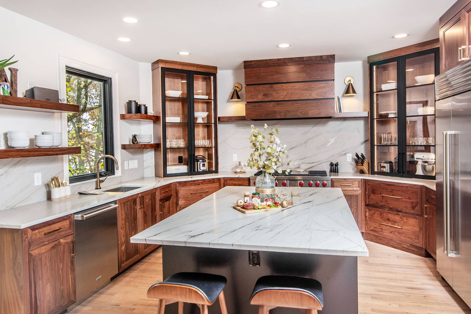 Kitchen cabinets with gold hardware and stainless steel appliances