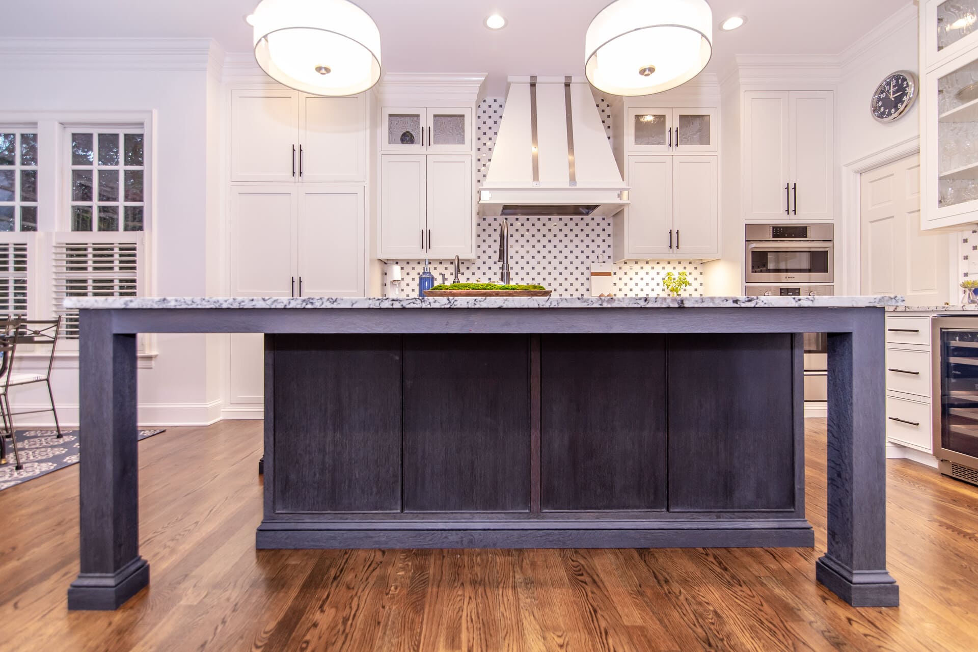 blue kitchen island with large light fixtures