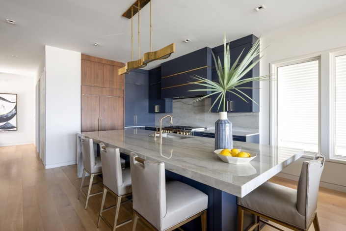 blue and walnut kitchen with a big island