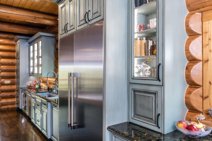 green kitchen with glass cabinet doors