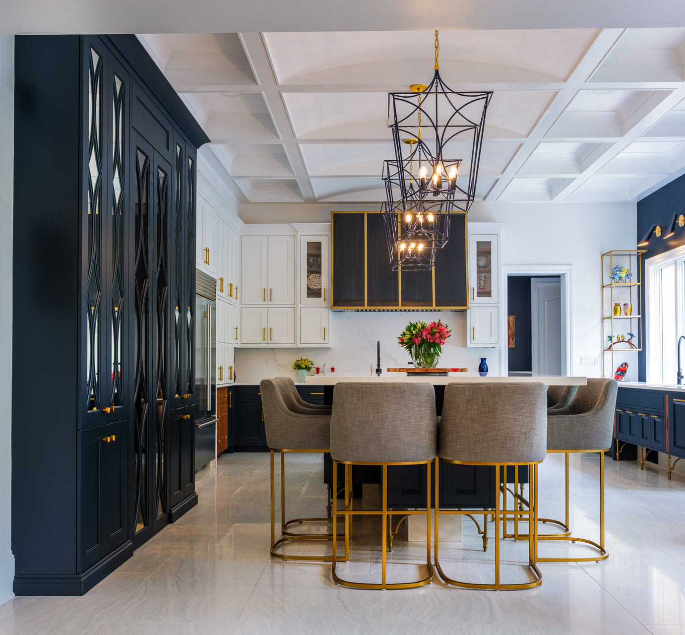 Custom blue and white kitchen with large light fixtures and an island
