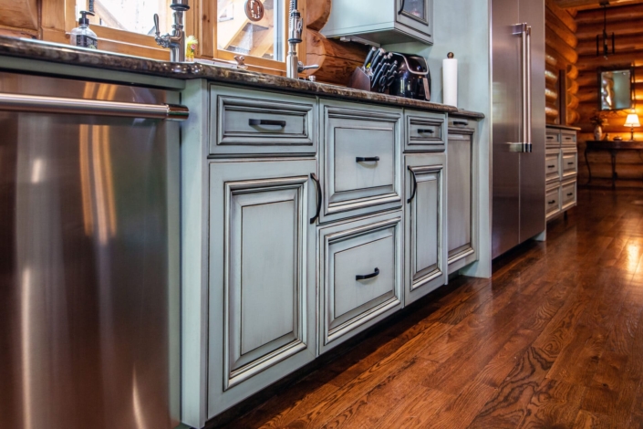 green kitchen with hardwood floors