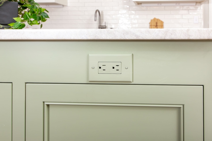 green outlet cover in island